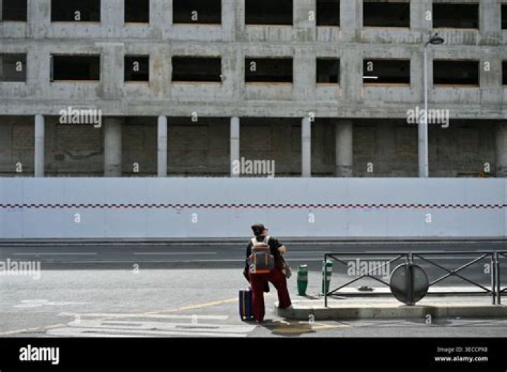 A Tourist Waits Outside The Palace