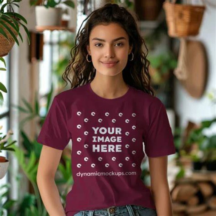 A woman wearing a maroon XIEERDUO v-neck puff sleeve top with jean shorts
