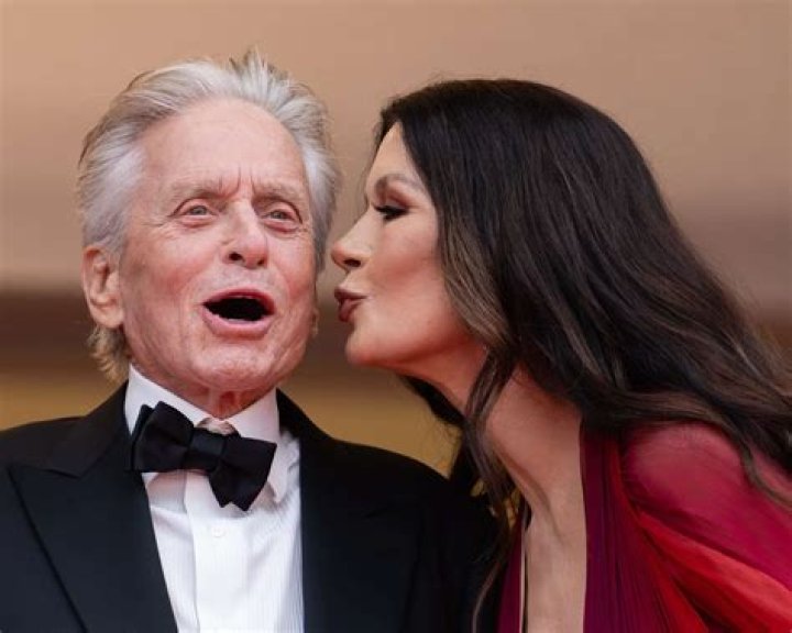 Actors Michael Douglas and Catherine Zeta Jones sit together at ringside before the start of the WBC/IBF Welterweight Championship fight between Oscar De La Hoya and Felix Trinidad at the Mandalay Bay Events Center in Las Vegas Saturday, Sept. 18, 1999. (AP Photo/Kevork Djansezian)