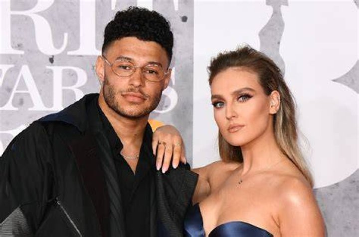 Alex Oxlade-Chamberlain, Perrie Edwards. Alex Oxlade-Chamberlain and Perrie Edwards of Little Mix pose for photographers upon arrival at the Brit Awards in London Brit Awards 2019 Arrivals, London, United Kingdom - 20 Feb 2019