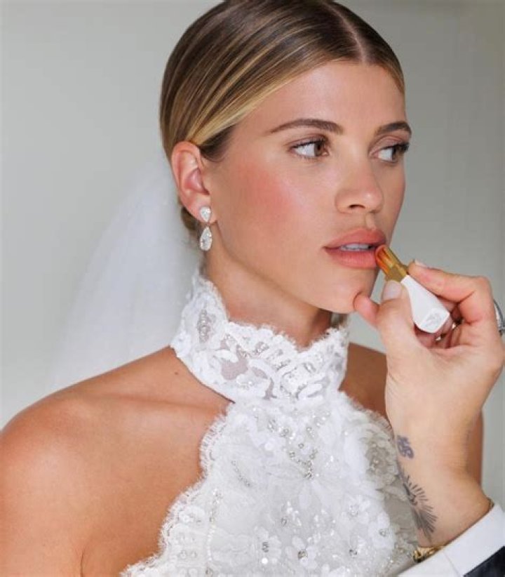 Blushing bride Sofia Richie looks radiant in an elegant white gown as she celebrates her lavish wedding weekend in the French Riviera. The model and daughter of legendary crooner Lionel Richie stepped out with her British fiance Elliot Grainge on Friday evening during their ultra glamorous trip to tie the knot in Antibes. It was unclear whether the happy couple were heading off to a fancy rehearsal dinner, or were dressed up for the nuptials. The stylish 24-year-old chose a demure, delicately beaded floor length ensemble for the occasion paired with white stilettos and wore her long hair in a chic up do. Her record executive groom, 30, looked dapper in a dark suit and tie as they were snapped by their team of photographers at their swanky hotel at sunset. Among the slew of A-list guests jetting in to watch them exchange vows are Cameron Diaz and Benji Madden, Sofia&rsquo;s sister Nicole Richie and husband Joel Madden, as well as her father Lionel Richie and brother Miles. 21 Apr 2023 Pictured: Sofia Richie , Elliot Grainge. Photo credit: EliotPress / MEGA TheMegaAgency.com +1 888 505 6342 (Mega Agency TagID: MEGA971732_027.jpg) [Photo via Mega Agency]