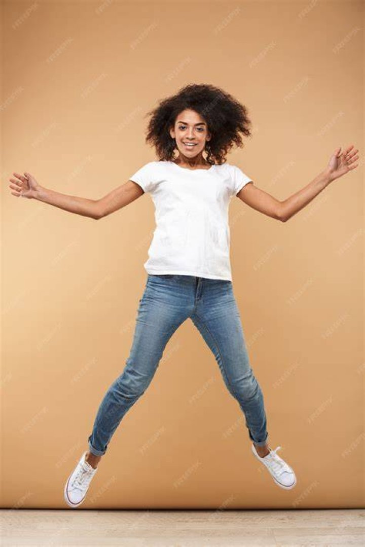 Cheerful young african woman with vivid makeup on her eyes. Female model laughing against yellow background.; Shutterstock ID 741676036; Comments: art use