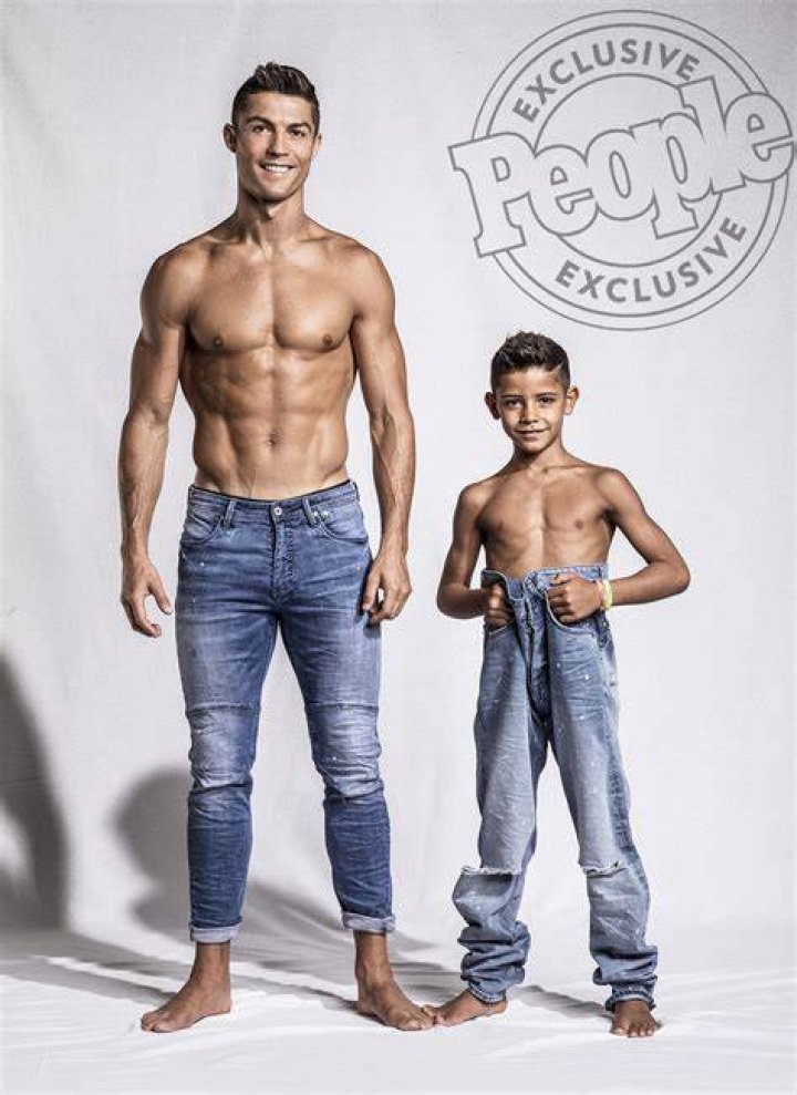 Cristiano Ronaldo and his mini-me are two peas in a pod in this very cute photoshoot for the football star&rsquo;s new CR7 Junior denim line. The 32-year-old Real Madrid player and his seven-year-old son, Cristiano Ronaldo Jr, pose up a storm, flexing their muscles while shirtless and donning matching outfits. The CR7 Junior collection is available exclusively on CR7.com and markets itself as the &ldquo;future of denim&rdquo; with &ldquo;unrivaled mobility&rdquo;. Speaking about the new line, Ronaldo explained: &ldquo;For me, the CR7 Junior collection is all about having fun and being free, being creative and confident. &ldquo;The stretch denim we have used in the collection is extremely comfortable due to the technical elements in the fabric, which will allow boys to&nbsp;run around and be active, move freely and most importantly, play.&rdquo; Ronaldo &mdash; who is also father to four-month-old twins Mateo and Eva Maria and whose girlfriend Georgina Rodriguez is pregnant with his fourth child &mdash; went on: &ldquo;This is why we have used the PRESS PLAY tagline for the brand. &ldquo;I believe the youth of today are the ones driving the society forward in so many ways and I felt that creating a denim collection&nbsp;with my son would celebrate&nbsp;this.&rdquo;. 14 Nov 2017 Pictured: Cristiano Ronaldo and his son Cristiano Ronaldo Jr. pose together in a photoshoot for the Real Madrid star's new CR7 Junior denim line. Photo credit: CR7/ MEGA TheMegaAgency.com +1 888 505 6342 (Mega Agency TagID: MEGA116703_002.jpg) [Photo via Mega Agency]