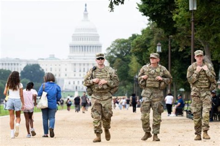 DC National Guard walk around the Capitol grounds, Thursday morning, Jan. 7, 2021 in Washington. The House and Senate certified the Democrat's electoral college win early Thursday after a violent throng of pro-Trump rioters spent hours Wednesday running rampant through the Capitol. A woman was fatally shot, windows were bashed and the mob forced shaken lawmakers and aides to flee the building, shielded by Capitol Police. (AP Photo/Julio Cortez)