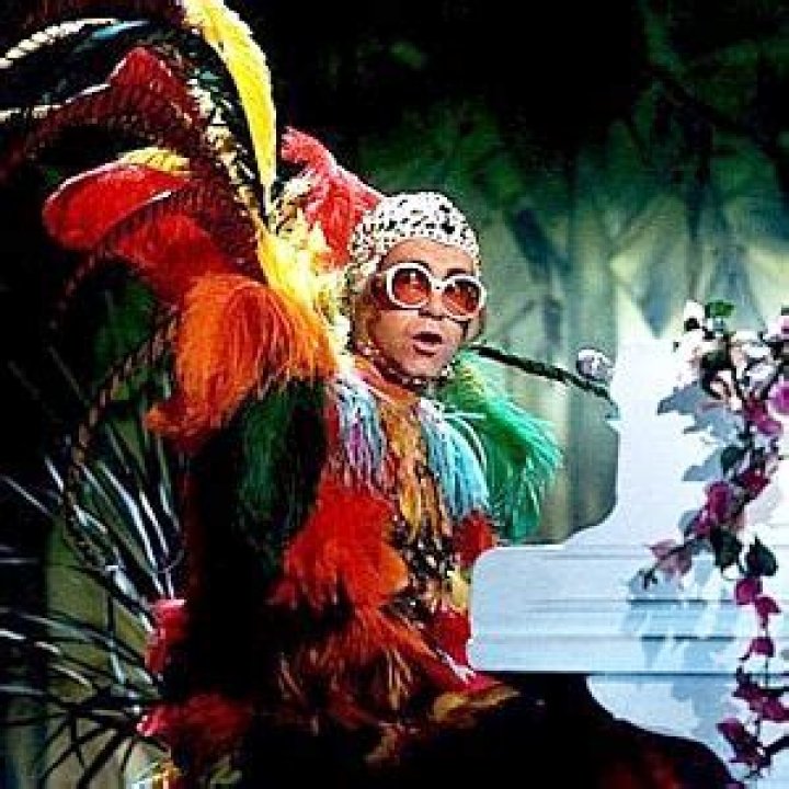 Elton John Dons Colorful Feathers