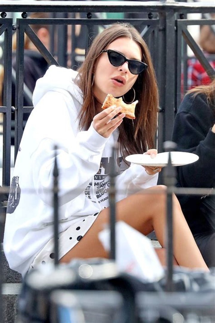 Emily Ratajkowski enjoys a slice of pizza while out with her husband Sebastian and their dog Colombo in Manhattan's Downtown area. The couple were seen spending the day at a dog park while cuddling and kissing. Then later Emily ate a slice of pizza by herself while her husband looked on. 28 Dec 2019 Pictured: Emily Ratajkowski. Photo credit: LRNYC / MEGA TheMegaAgency.com +1 888 505 6342 (Mega Agency TagID: MEGA575009_003.jpg) [Photo via Mega Agency]