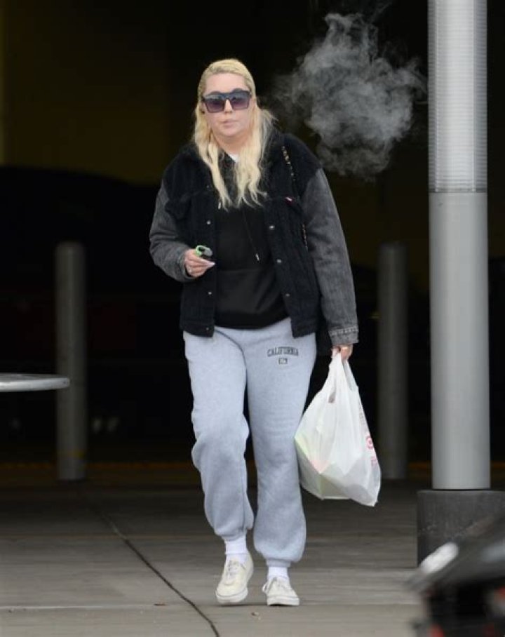 EXCLUSIVE: Amanda Bynes runs errands in Los Angeles on the heels of news that she has rekindled her romance with her ex-fiance Paul Michael. The former child TV actress, who is now studying to become a manicurist, stopped by a 7-11 for a quick coffee and then headed to CVS for a few essentials. The heart tattoo on her left cheek, which she has been in the process of having removed, was still visible and she sported long white nails, vaping as she walked. Bynes, 36, accessorized with large gold earrings which appeared to be Christian Dior designer brand, and a nose ring. 24 Oct 2022 Pictured: Amanda Bynes. Photo credit: Snorlax / MEGA TheMegaAgency.com +1 888 505 6342 (Mega Agency TagID: MEGA910952_007.jpg) [Photo via Mega Agency]