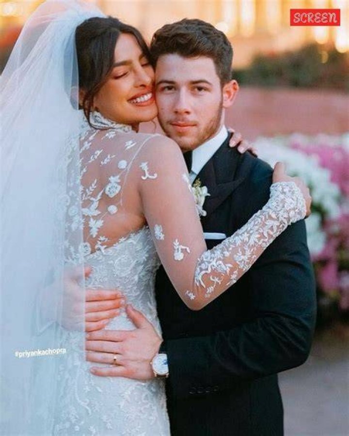 EXCLUSIVE: Nick Jonas and wife Priyanka Chopra Jonas go sightseeing around London ahead of the Christmas holidays. The couple, who have been married for two years, wore face masks and stopped for a hot drink at a cafe. The Bollywood actress who is in town to film 'Text for You', looked positively glowing. The happy couple could be seen stopping for Nick to take some funny photos of Priyanka next to a Highway Maintenance van, presumably to have the words &lsquo;High Maintenance&rsquo; behind her. The loved up pair could be seen walking along with Priyanka&rsquo;s mother in tow, always a couple of yards behind them. Nick, 28, and Priyanka, 38, could be seen wearing Christmas colors, with Nick in a green beanie hat and green accented checked woolen overcoat, while Priyanka opted for a dark brown leather jacket with red and pink knitted top, beanie hat, and jeans. 09 Dec 2020 Pictured: Nick Jonas, Priyanka Chopra Jonas. Photo credit: MEGA TheMegaAgency.com +1 888 505 6342 (Mega Agency TagID: MEGA720310_003.jpg) [Photo via Mega Agency]