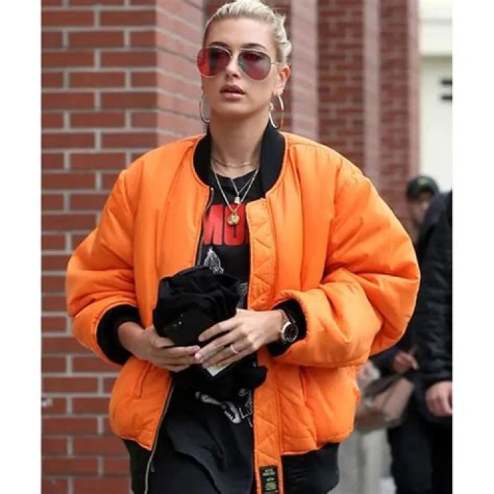 Hailey Baldwin in an orange and turquoise tank top