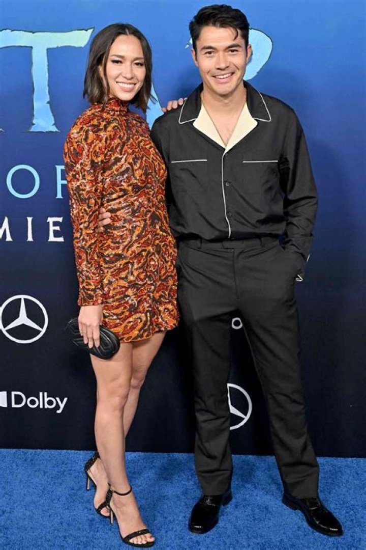 Henry Golding & Liv Lo lift their arms