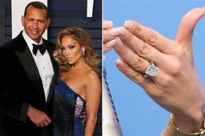 Jennifer Lopez & Alex Rodriguez holding signs