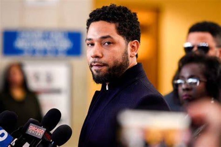 Jussie Smollett holds his copy of a magazine
