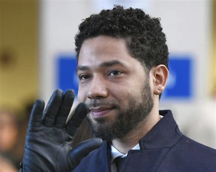 Jussie Smollett smiles at a magazine launch