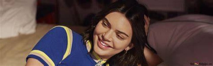 Kris Jenner smiling with Kendall and Kylie