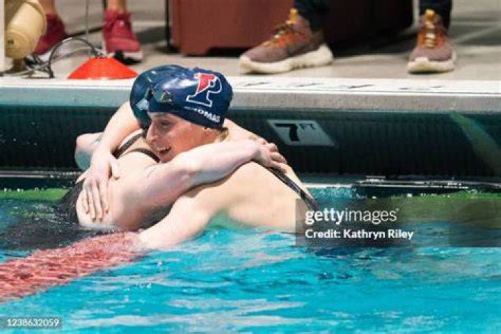 Lia Thomas hugs a fellow swimmer