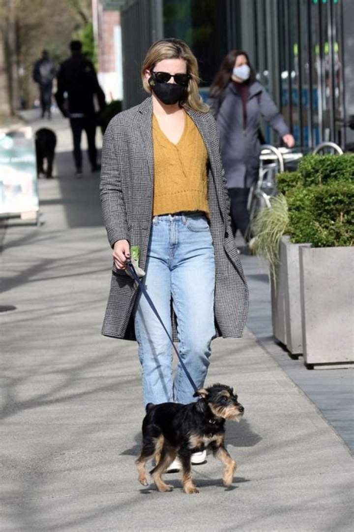 Lili Reinhart walking with a sign