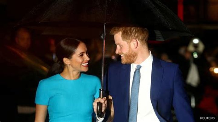 Meghan Markle and Prince Harry hold hands
