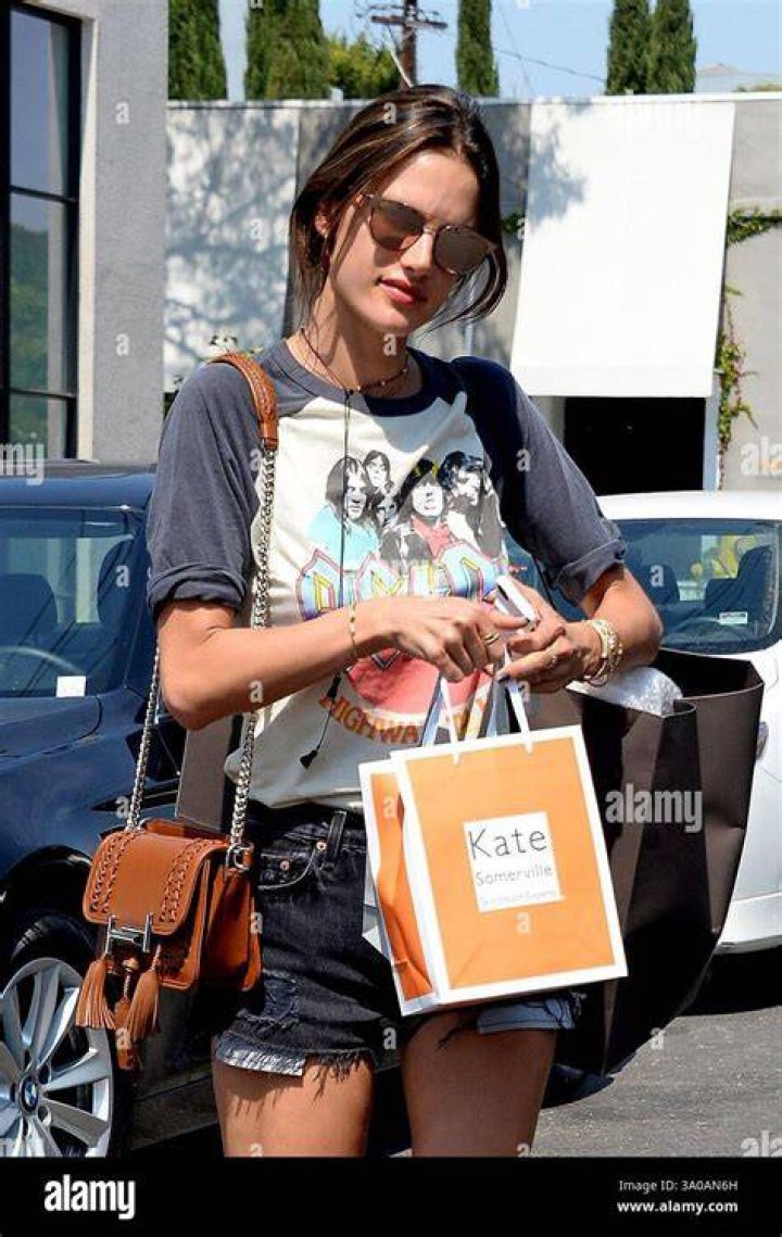 Model Alessandra Ambrosio wears short shorts jeans and a white t-shirt as she goes to Gracias Madre for lunch on a hot sunny day