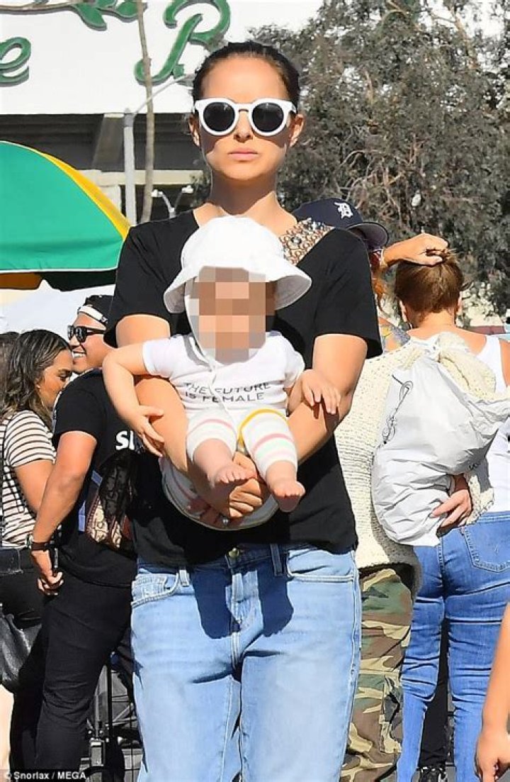 Natalie Cuddles Her Daughter Amalia While Arriving In NYC