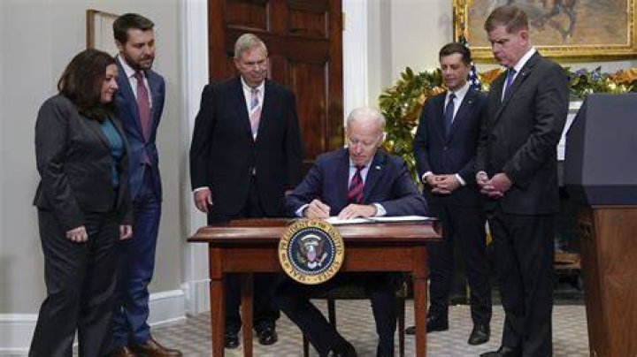 President Joe Biden signs the book of condolences