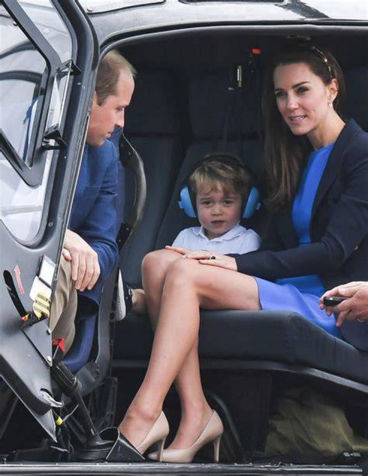 Prince George sits on the grass