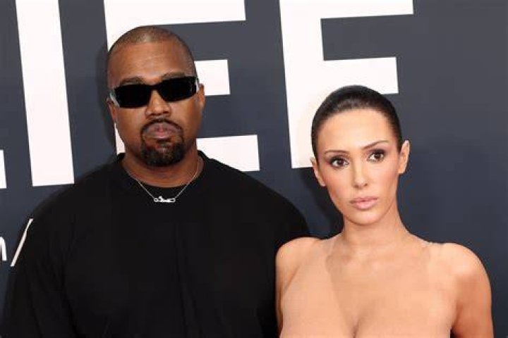 Rapper Kanye West and girlfriend Chaney Jones attend a game between the Miami Heat and the Minnesota Timberwolves at FTX Arena Celebrities at Miami Heat v Minnesota Timberwolves, Basketball at FTX Arena, Miami, Florida, USA - 12 Mar 2022