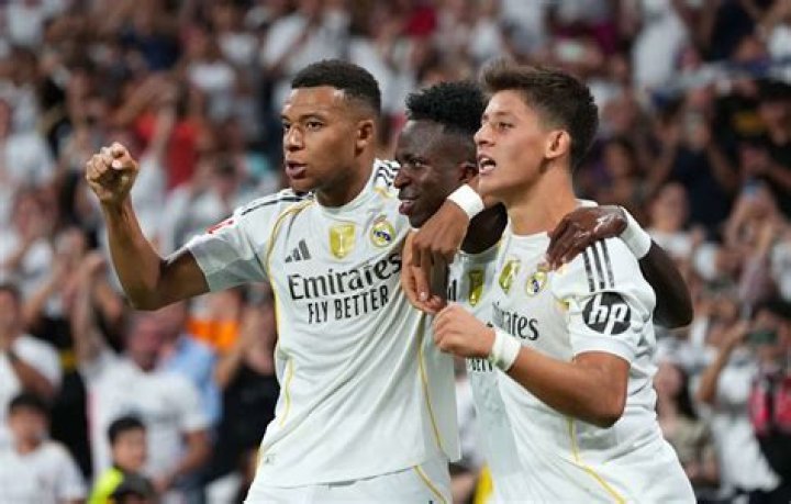 Real Madrid's Isco, left, celebrates with teammates after scoring his side's opening goal during the Champions League, round of 16, first leg soccer match between Real Madrid and Manchester City at the Santiago Bernabeu stadium in Madrid, Spain Soccer Champions League, Madrid, Spain - 26 Feb 2020