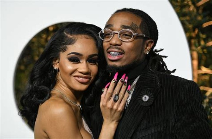 Saweetie, left, and Quavo kiss as they arrive at GQ's Men of the Year Celebration on Thursday, Dec. 5, 2019, in West Hollywood, Calif. (Photo by Richard Shotwell/Invision/AP)