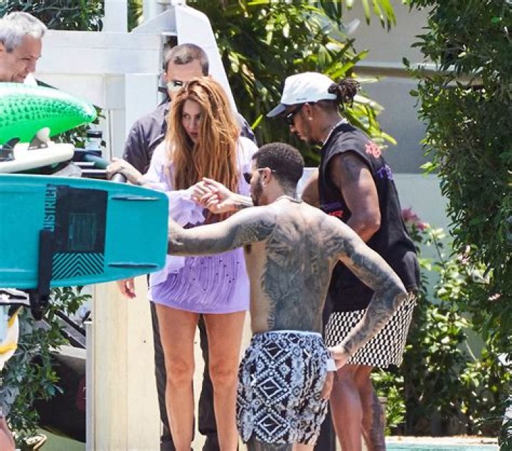 Shakira sparks new romance rumors as she enjoys a Miami boat trip with F1 ace Lewis Hamilton hours after the pair crossed paths at a fancy restaurant. The newly single and highly eligible bachelorette was picked up by the British-born racing star at the back of her own $20 million Miami Beach mansion on Wednesday. She was seen accepting Hamilton's offer of a hand, with the decorated Mercedes driver promptly got to his feet as she climbed aboard. They were accompanied on the cruise by heavily tattooed American fencer Miles Chamley-Watson, one of Hamilton's closest friends. It came the day after the two had crossed paths as Shakira made her way into Miami's upscale Cipriani restaurant, where Hamilton was dining out with pals on Tuesday evening. Speculation is now mounting around a potential new love match for the 46-year-old pop diva, who was also linked to Tom Cruise earlier this week amid reports the actor was "extremely interested" in pursuing her after they chatted at the Miami Grand Prix last weekend. But it seems she may be more interested in Hamilton, who competed in the flashy event. On Wednesday, she showed off her toned legs and torso in a flirty fringed lilac bikini top and matching shorts, wearing her famous long wavy hair loose over her shoulders. She was all smiles as she boarded the vessel which pulled up on Biscayne Bay behind her lavish waterfront pad. The 'Hips Don't Lie' songstress returned later on looking relaxed and went barefoot as she climbed back onto her personal dock. Shakira is newly single after splitting from soccer star Gerard Pique after 12 years. The former couple share two children, Sasha, 8, and Milan, 10. 10 May 2023 Pictured: Shakira and Lewis Hamilton. Photo credit: RM/MEGA TheMegaAgency.com +1 888 505 6342 (Mega Agency TagID: MEGA979957_039.jpg) [Photo via Mega Agency]