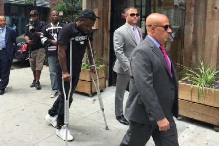 Troy Ave walks on crutches