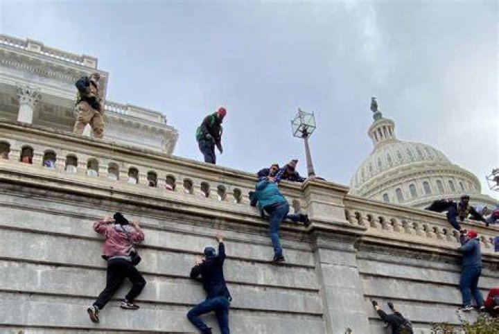 Trump Supporters Climb A Wall Outside The U.S. Capitol