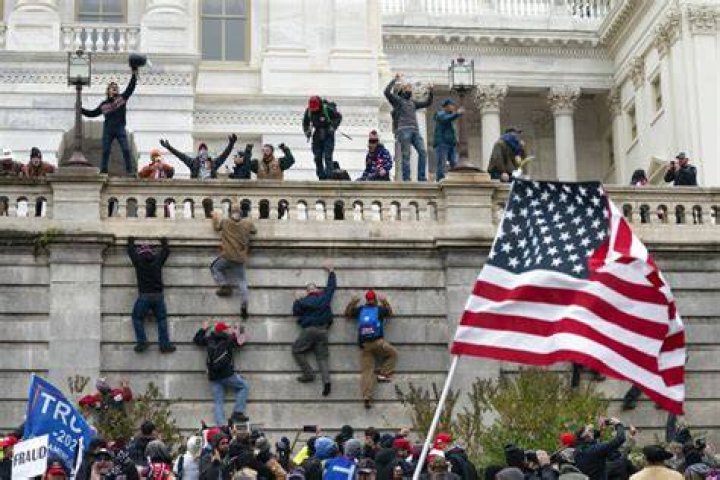 UNITED STATES - January 7: The East Front of the U.S. Capitol is seen through a shattered door leading to the center steps in Washington on Thursday, Jan. 7, 2021, following the riot at the Capitol the day before. (Photo by Caroline Brehman/CQ Roll Call via AP Images)