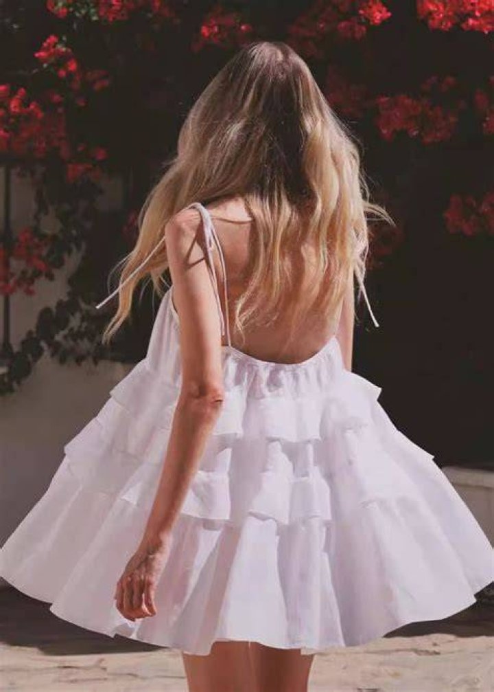 Woman wearing red ruffle sundress.